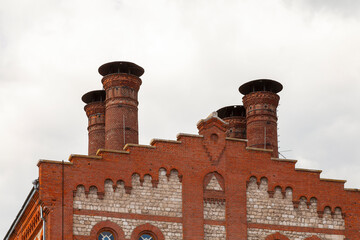 Brick chimneys of an old factory against the sky
