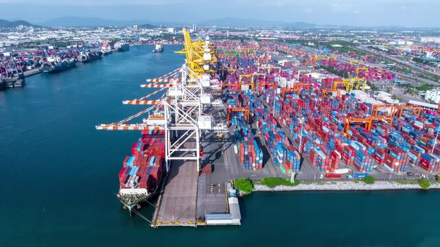 Aerial top view hyperlapse container cargo ship international port terminal with gantry crane, industrial cargo container port loading and unloading, Global business logistic import export.