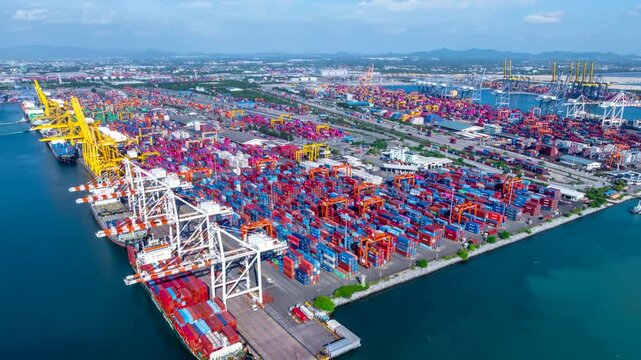 Aerial top view hyperlapse container cargo ship international port terminal with gantry crane, industrial cargo container port loading and unloading, Global business logistic import export.
