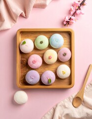 Flat Lay of Japanese Mochi Desserts in Assorted Colors with Powdered Sugar on Neutral Background