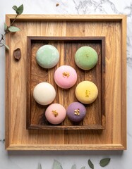 Flat Lay of Japanese Mochi Desserts in Assorted Colors with Powdered Sugar on Neutral Background
