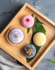 Flat Lay of Japanese Mochi Desserts in Assorted Colors with Powdered Sugar on Neutral Background
