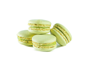 Four green pistachio macaroons isolated on white background.