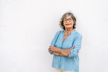Senior woman smiling confident with arms crossed