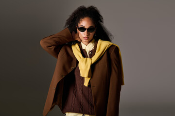 Stylish autumn look featuring a confident woman in a trendy studio setting