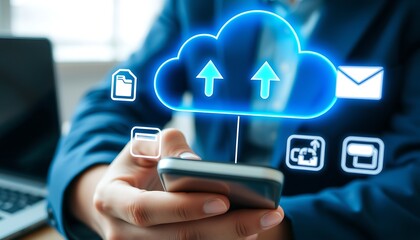 Person using smartphone with cloud upload and file icons in office setting cloud computing data transfer