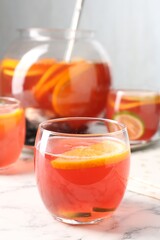 Fruity punch on white marble table, closeup. Refreshing drink