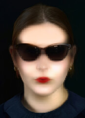 Face of a beautiful young woman wearing sunglasses behind frosted glass