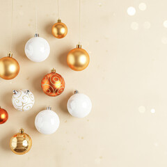 Colorful holiday ornaments hang against a light background, creating a festive and cheerful atmosphere perfect for celebrations.