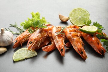 Tasty grilled shrimps with spices on grey table, closeup. Delicious seafood dish
