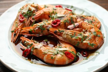 Tasty grilled shrimps with spices and sauce on plate, closeup. Delicious seafood dish