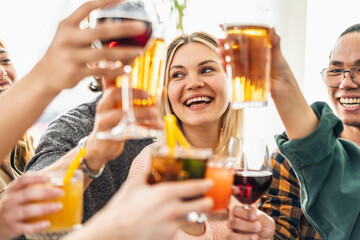 Multiracial friends celebrating party drinking cocktails at bar restaurant - Young people having fun hanging out on weekend day - Life style concept with guys and girls enjoying time together