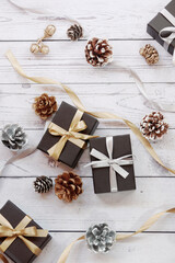 Christmas gift boxes and decorations on wooden table. Preparation for holidays. Copy space. Christmas background.