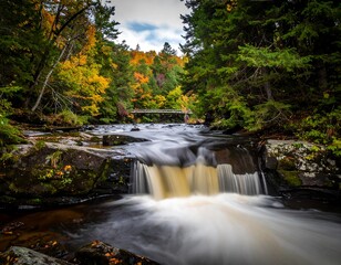 Autumnal waterfall cascading through a rocky stream bed