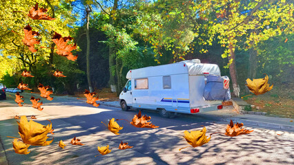car caravan under yellow autumn trees