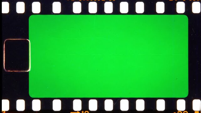 Vintage 35mm film strip running with green screen frames