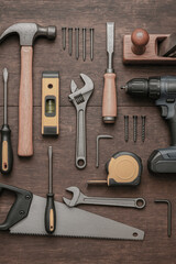 Variety of tools on wooden background. Top view with copy space