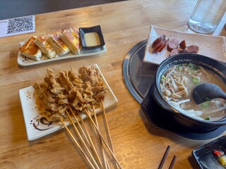 Chinese lamb guts skewers with white soup and sausages.