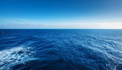 Fototapeta premium Vast Deep Blue Ocean Stretches To The Horizon Untouched And Serene Sunlight Glints On The Endless Waves A Mesmerizing Display Of Nature S Power And Beauty Vast Bright Day
