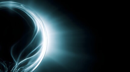 Abstract glowing blue energy orb with light rays on black background image