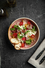 Colorful vegetable salad with radish, cherry tomatoes and bread slices