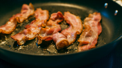 Close-up of Bacon Frying and Curling in a Pan