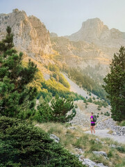 Obraz premium Woman with Tourist Backpack on Hiking Adventure in Mountains