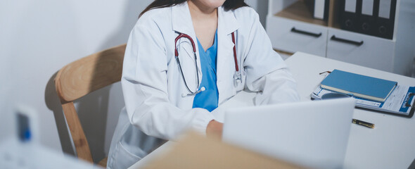 Receptionist working at the hospital registering patients