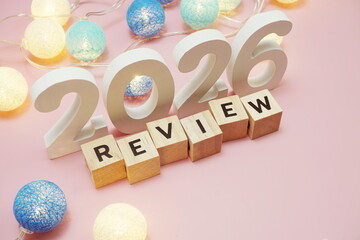 Review 2026 word alphabet letters on pink background
