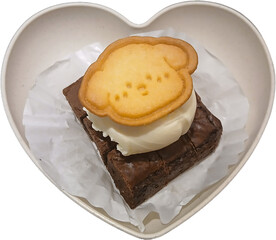Sweet brownie dessert with ice cream and cloud cookie in heart bowl