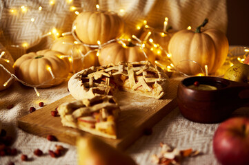 Cozy Autumn Pie Scene With Mini Pumpkins, String Lights, And Apple Pie On Board
