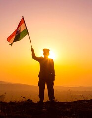 Silhouette soldier holding Indian flag at sunrise