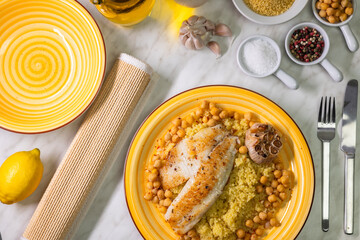 grilled cod with couscous, chicken pea and baked garlic