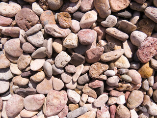 Beach rocks, background, Large coastal rocks on a Greek beach. Natural stone background for travel, design, and relaxation. Ideal concept for summer holiday, seaside beauty, and coastal landscapes.