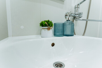 Stylish Modern Bathroom Decor with Greenery and Textured Glass Vases