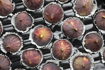 Fresh ripe figs in plastic container, top view
