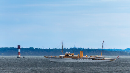 Aufnahme der königlichen Yacht von Dänemark bei einem Leuchtturm.