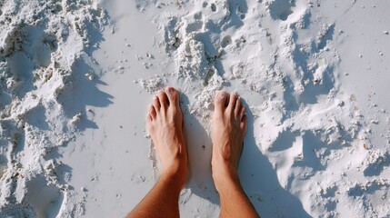 Bare feet feeling soft sand on a sunny beach during a relaxing day out