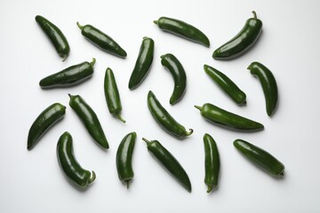 Green jalapeno peppers on white background, flat lay