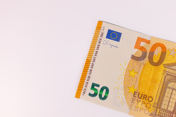 Close-up of a 50 euro banknote on a white background, symbolizing finance, currency, savings, wealth, or economic value.