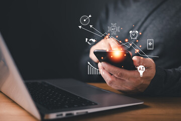 person use smartphone with glow AI icons,graph,and digital symbol representing technology,analytics,innovation,productivity,automation,decision making,modern business strategy,and data-driven growth.