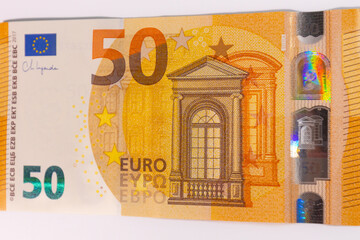 Close-up of a 50 euro banknote on a white background, symbolizing finance, currency, savings,...