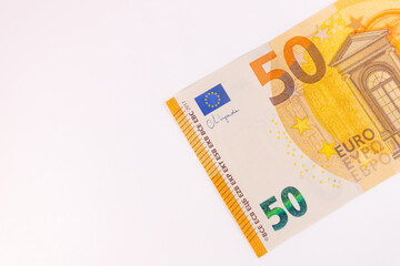Close-up of a 50 euro banknote on a white background, symbolizing finance, currency, savings, wealth, or economic value.