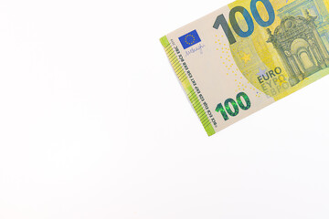 Close-up of a 100 euro banknote on a white background, symbolizing finance, wealth, savings, currency, or economic value.