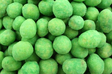 Tasty wasabi coated peanuts as background, closeup