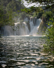 Naklejka premium A Framed View: The Serene Beauty of Skradinski Buk
