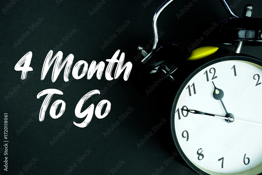 Poster 4 month to go text and alarm clock on black background