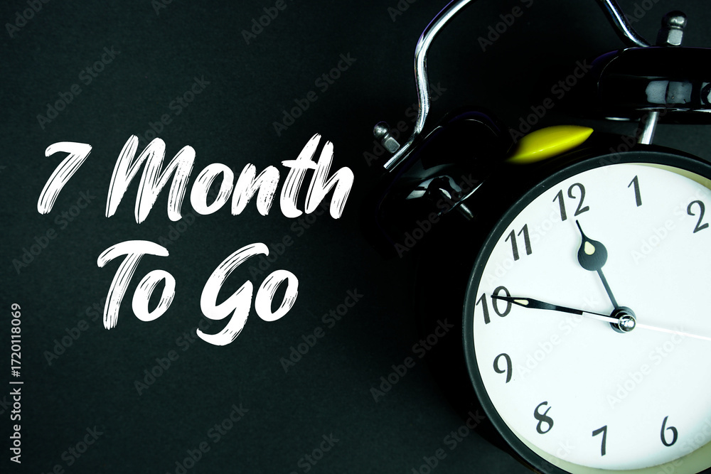 Poster 7 month to go text and alarm clock on black background