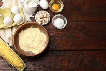 Cornbread preparation. Different ingredients on wooden table, flat lay. Space for text