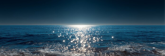 Tranquil ocean view with sparkling water under a clear sky at twilight.